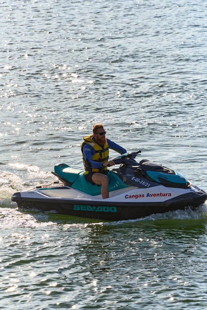 Person riding a jet ski in Llanes, Spain, enjoying a summer adventure.